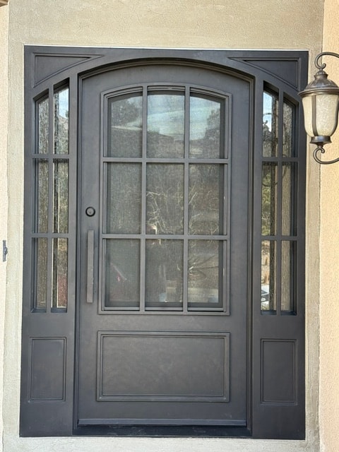 Iron door with sidelights stucco exterior