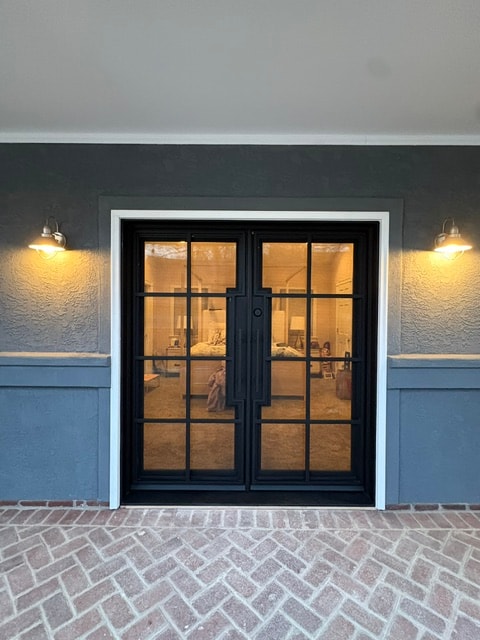 Iron French doors warm interior lighting
