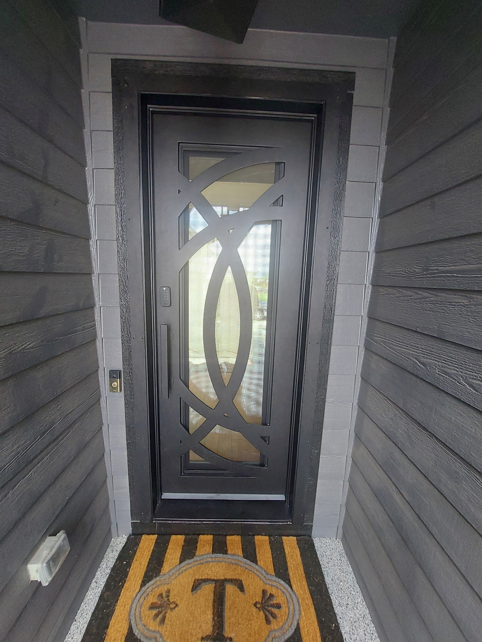 After — new Colorado Iron Door with geometric glass panels installed