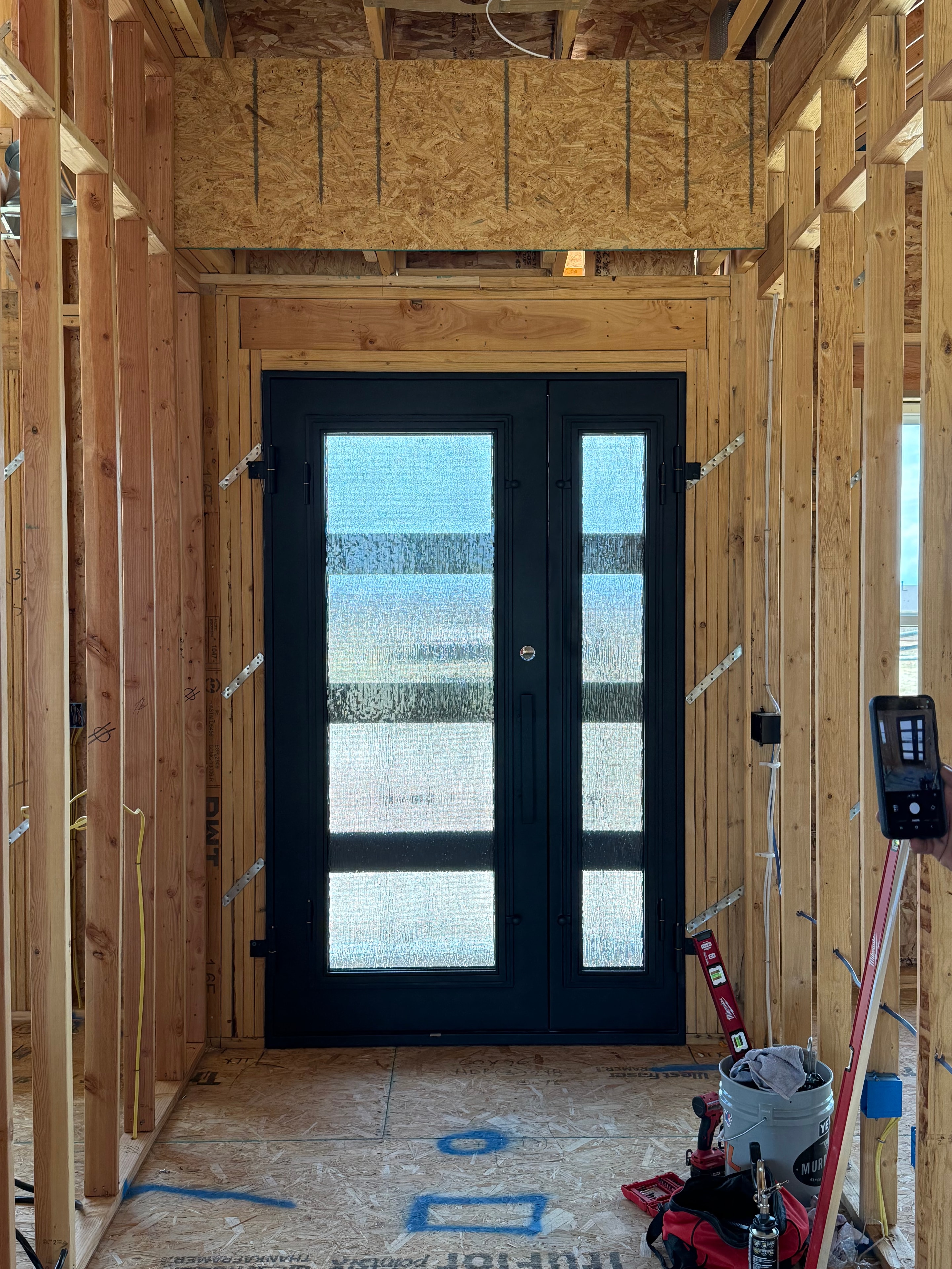 Iron door with textured glass panels, interior framing view