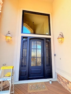 Iron door entryway with wall sconces